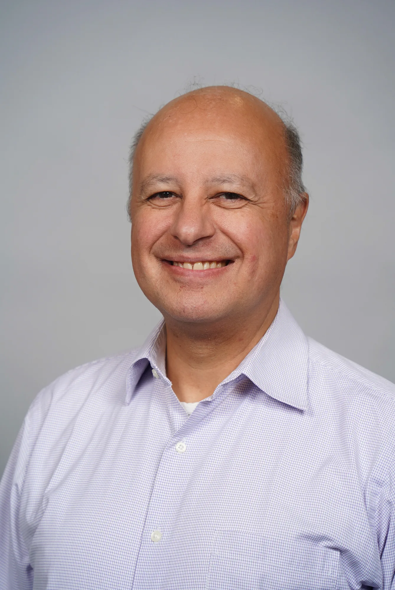 Carlos Arocha in a relaxed professional portrait